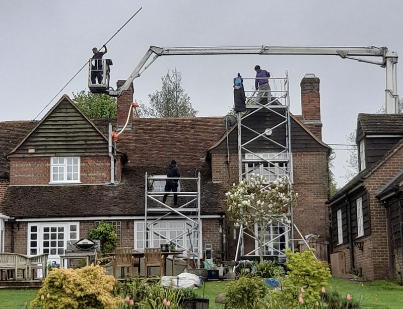 The Roof Moss Cleaners using cherry picker and scaffolding to clean roof safely and professionally in Littleport, Cambridgeshire